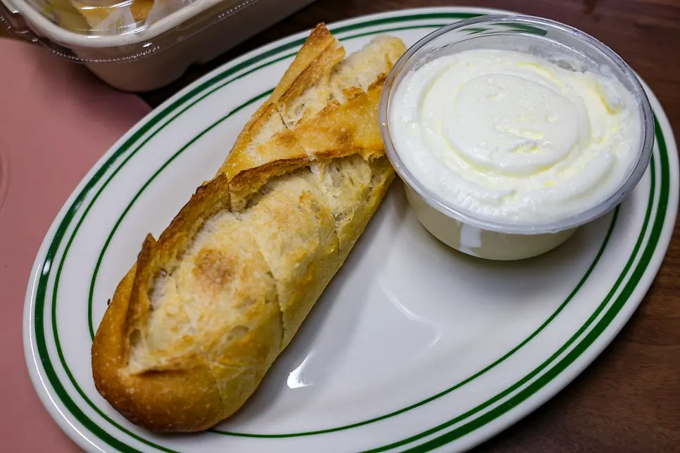 French baguette sliced and packed to go