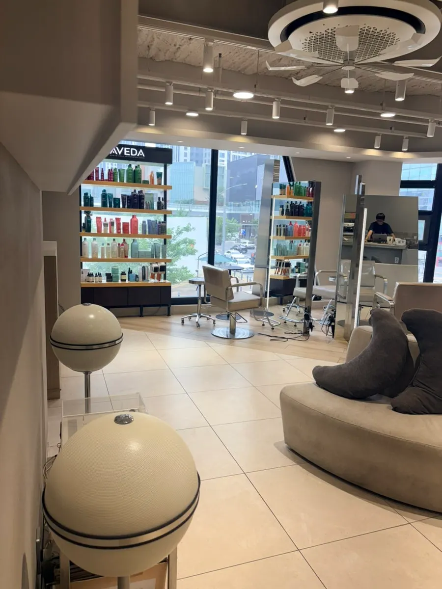 Salon space with atmospheric lighting and mirrors