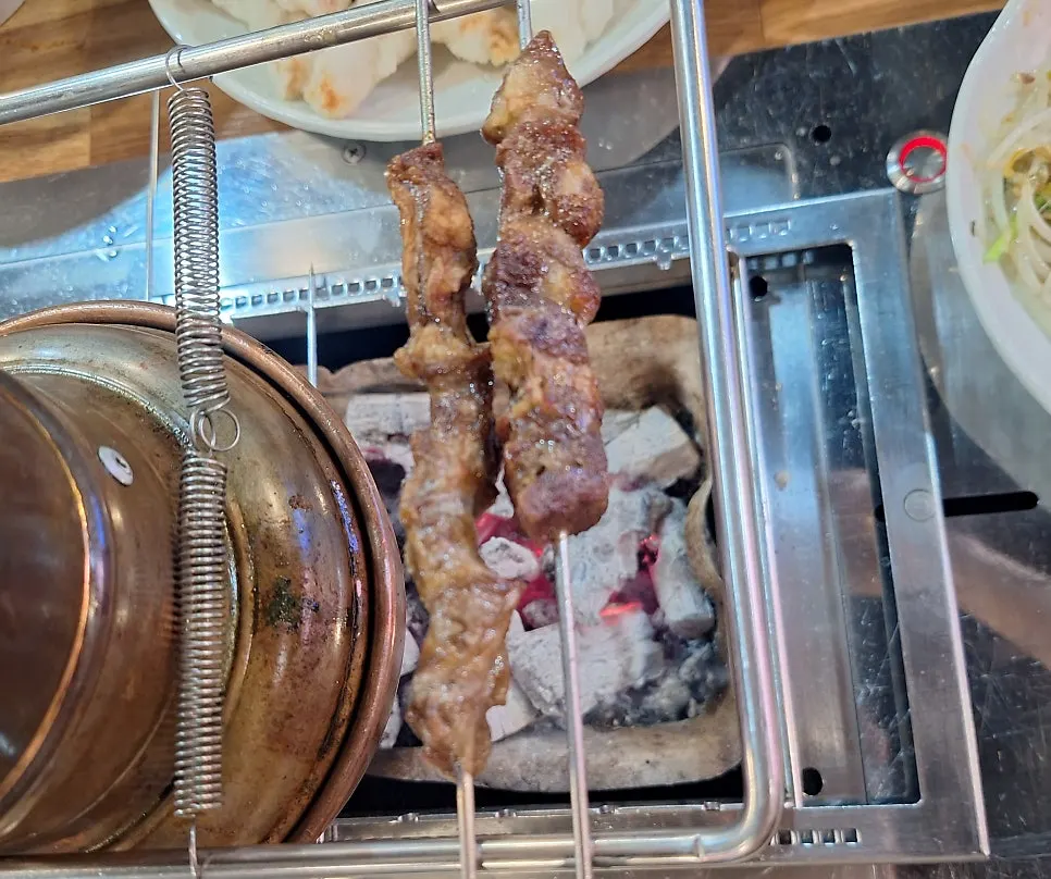 Lamb skewers well-cooked over charcoal