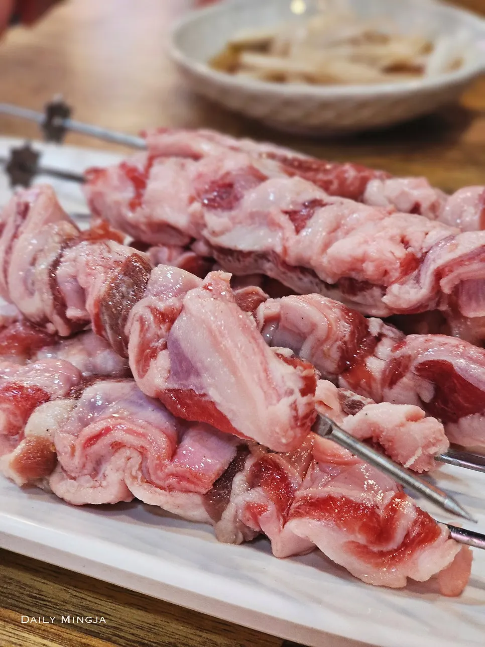 Thick lamb rib meat skewers placed on the charcoal grill