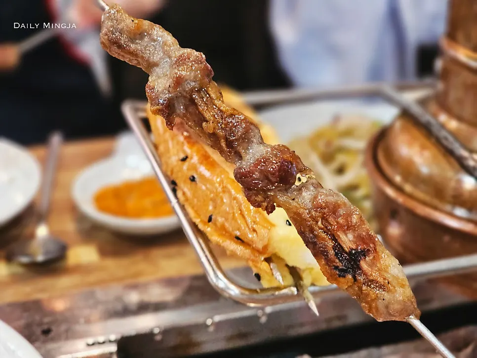 A piece of lamb rib meat dipped in cumin seasoning