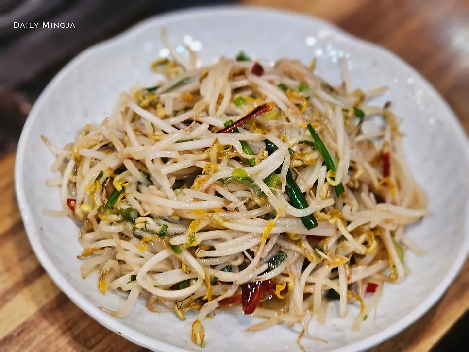 Complimentary bean sprout stir-fry served on a plate