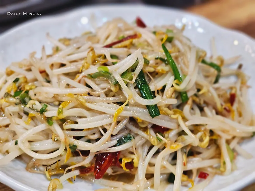 Crunchy bean sprout stir-fry lifted with chopsticks
