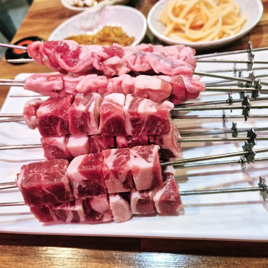 Yang kkochi skewers cooking on the grill