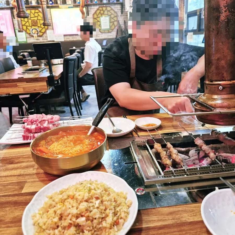 Skewers lined up together on the rotating grill