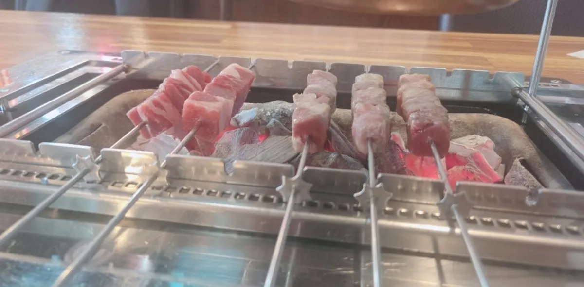 Lamb skewers placed on the charcoal grill