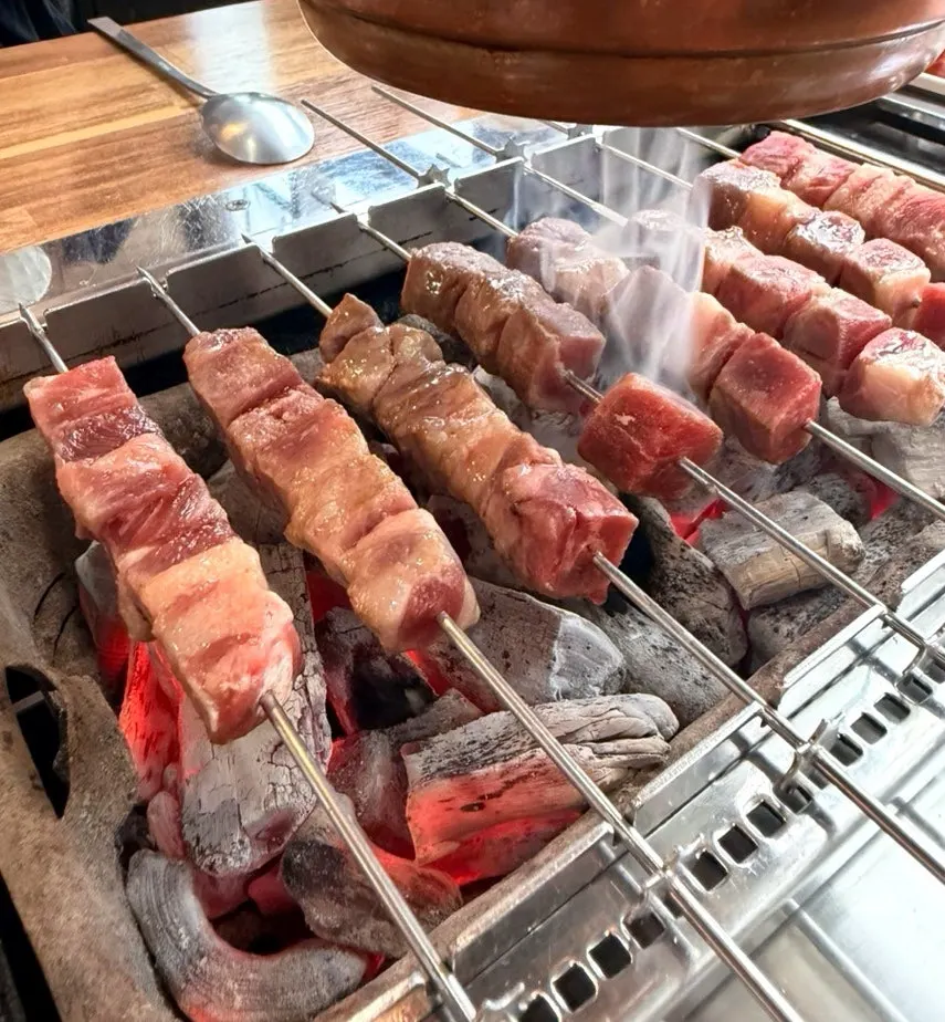 Lamb skewers grilling on the auto-rotating grill