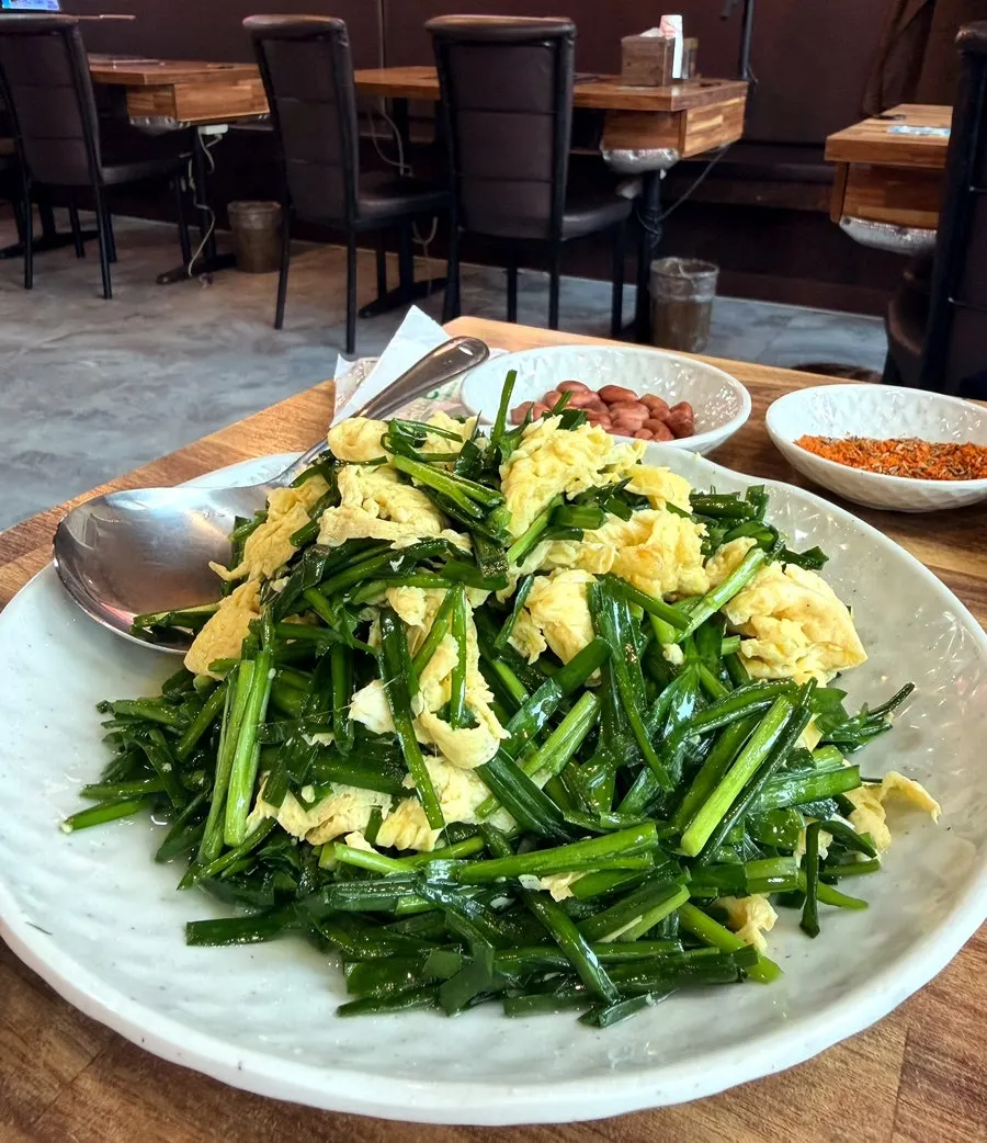 A steaming plate of chive egg stir-fry