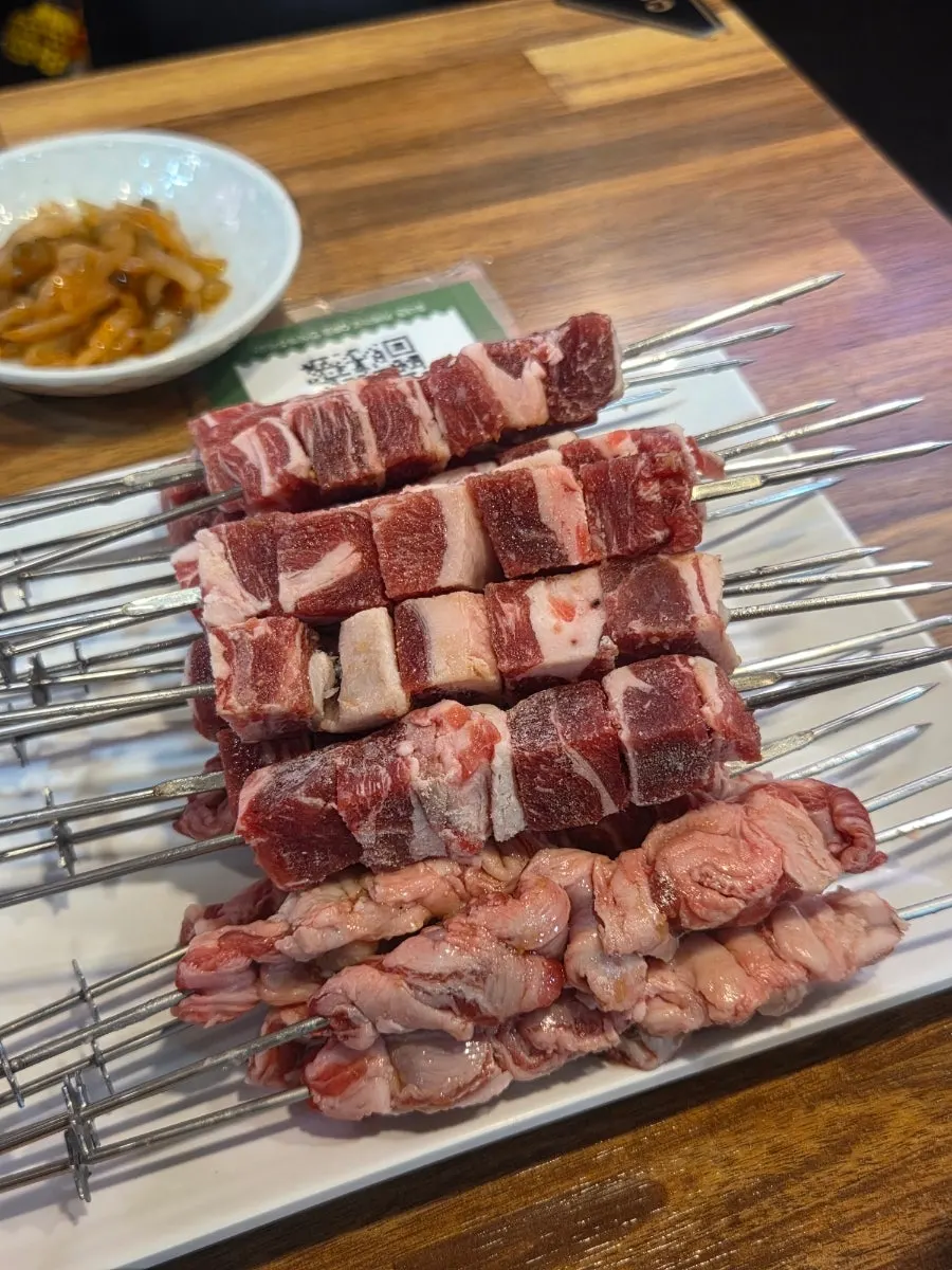 Plate of radish salad and pickled mustard root among other side dishes
