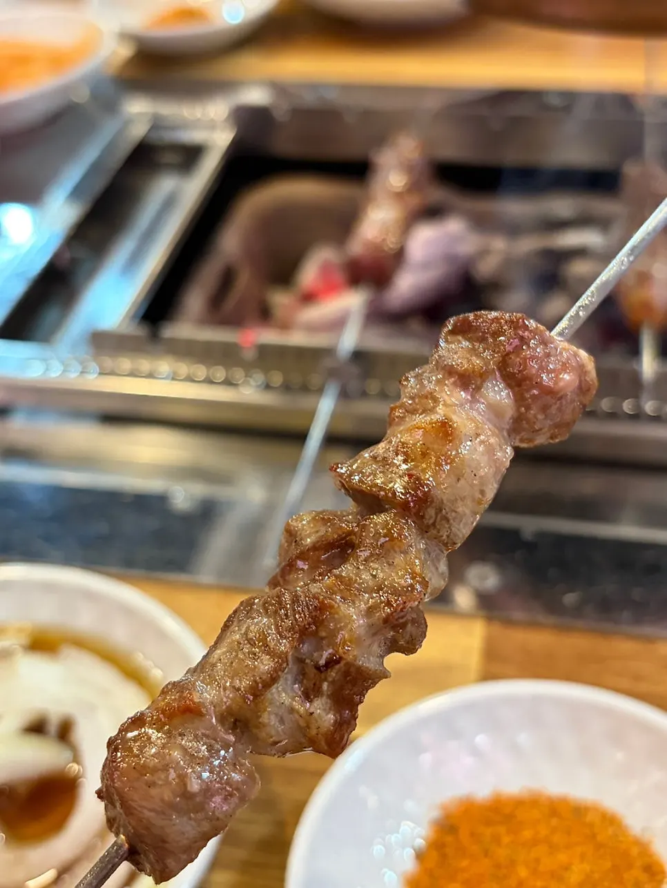 Lamb skewers grilling over charcoal