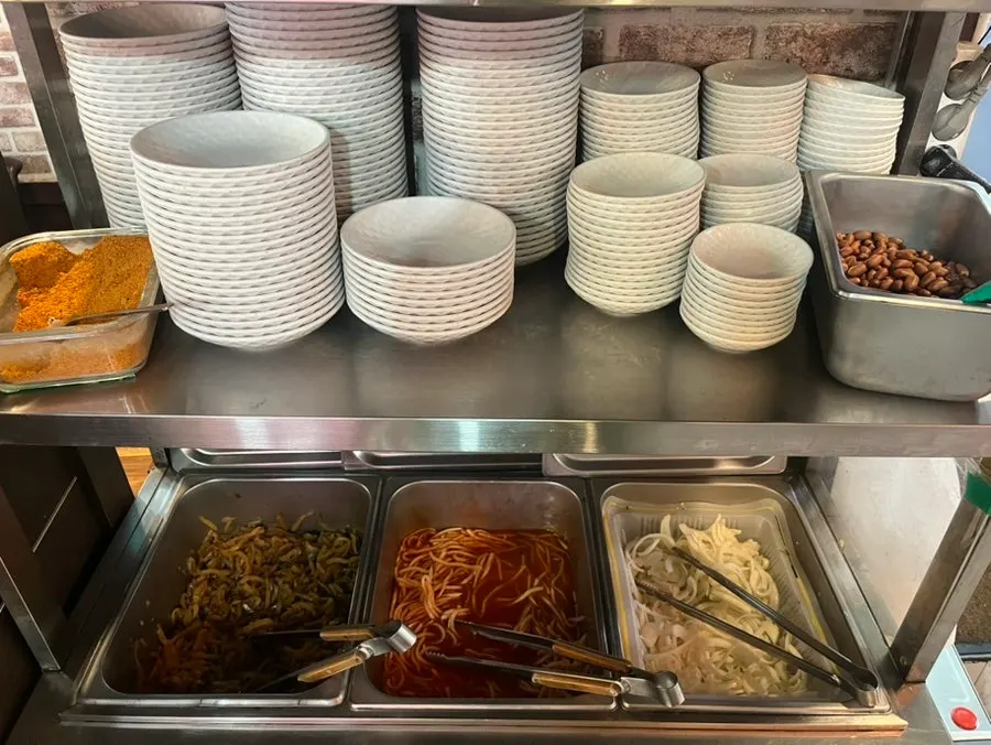 Self-serve bar with side dishes and sauces