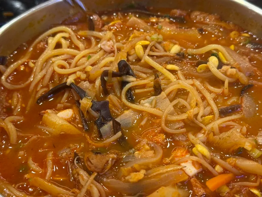 Scooping up jjamppong ingredients