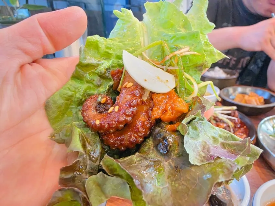 A lettuce wrap with octopus and ssamjang