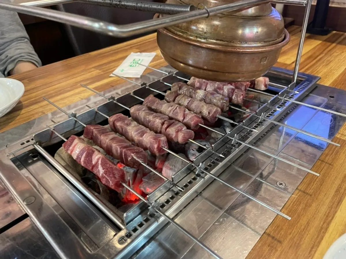 Table spread with lamb skewers and Chinese dishes