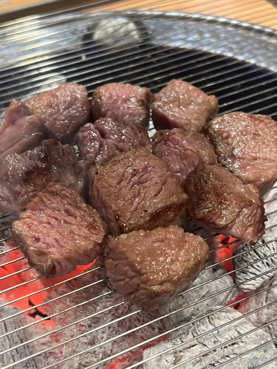 Cubed short rib grilling over charcoal