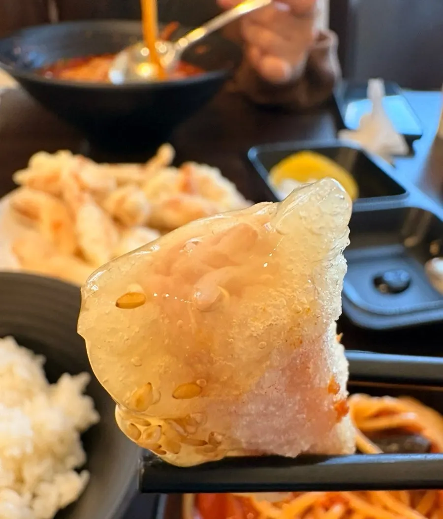 Dipping tangsuyuk into the sauce