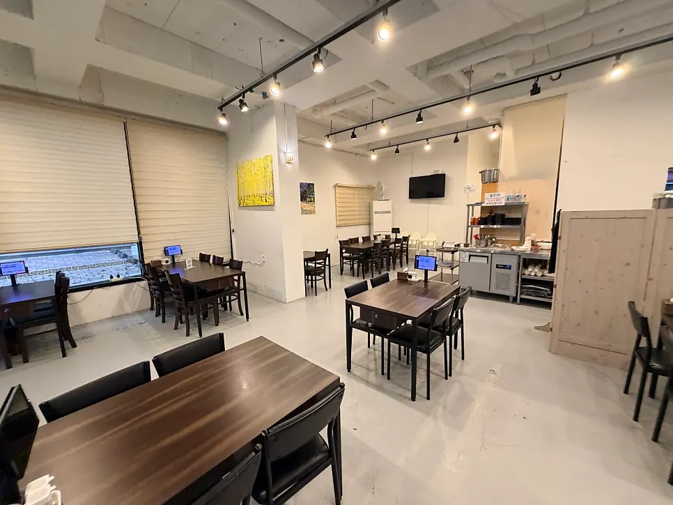 Spacious interior with large tables at Bongga Gyodong Banjeom