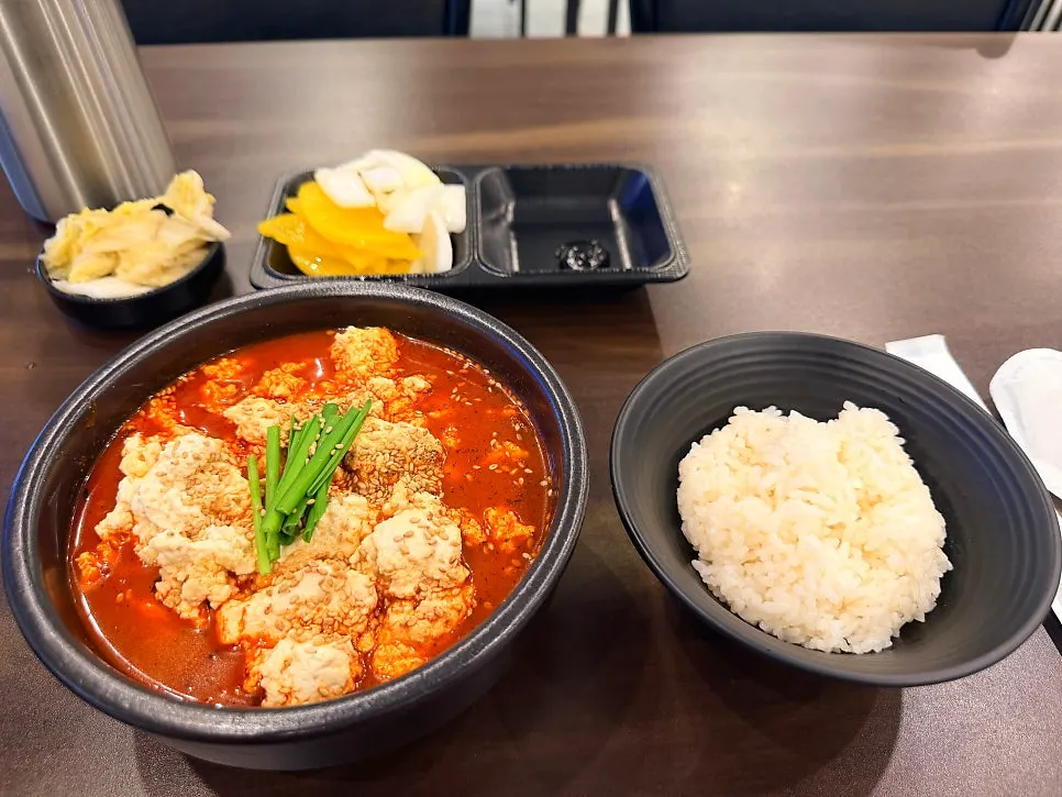A generous bowl of sundubu jjambbong rice set on the table
