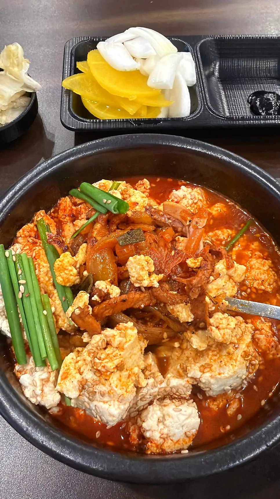 Soft tofu piled high on top of the broth