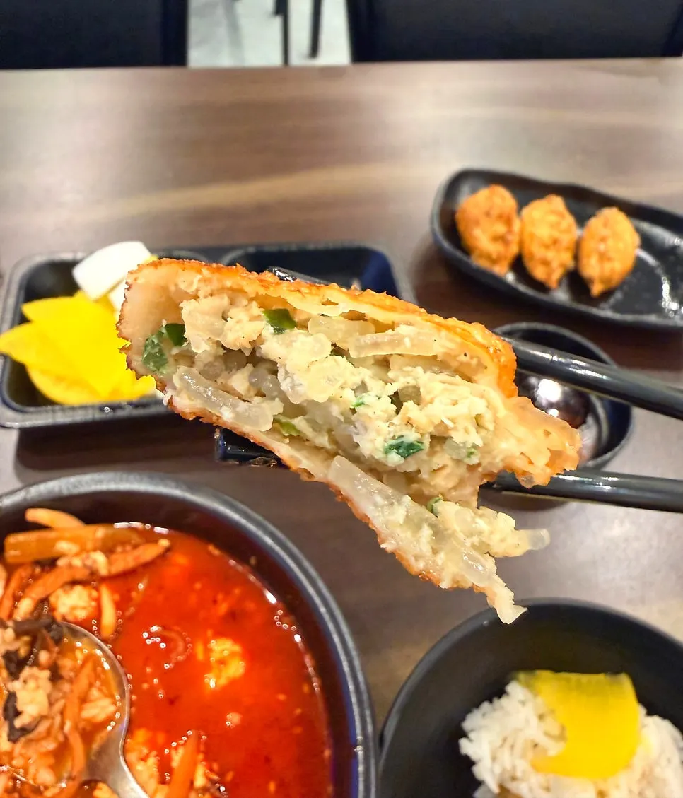 Cross-section of a fried mandu packed with meat filling