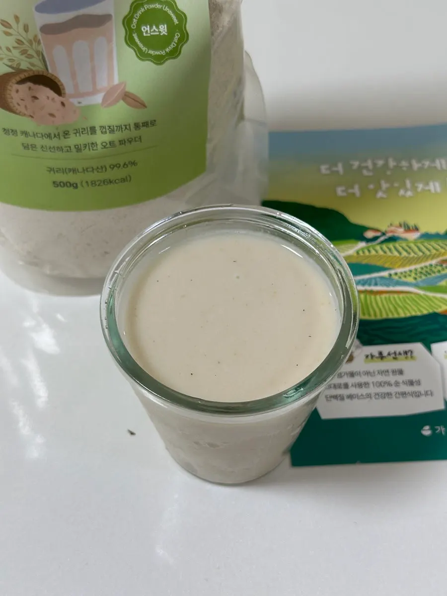 A glass of the oat drink mixed thick with water