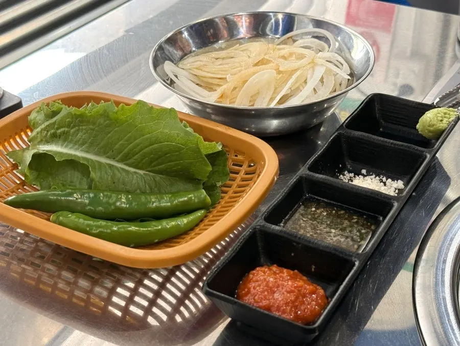 Lettuce wraps, onion, and kimchi side dish spread