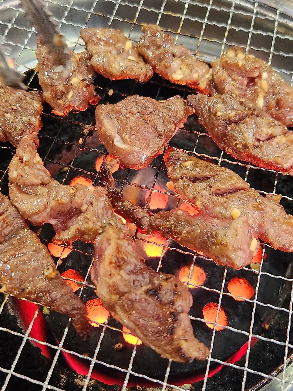 Meat grilling over gentle charcoal heat