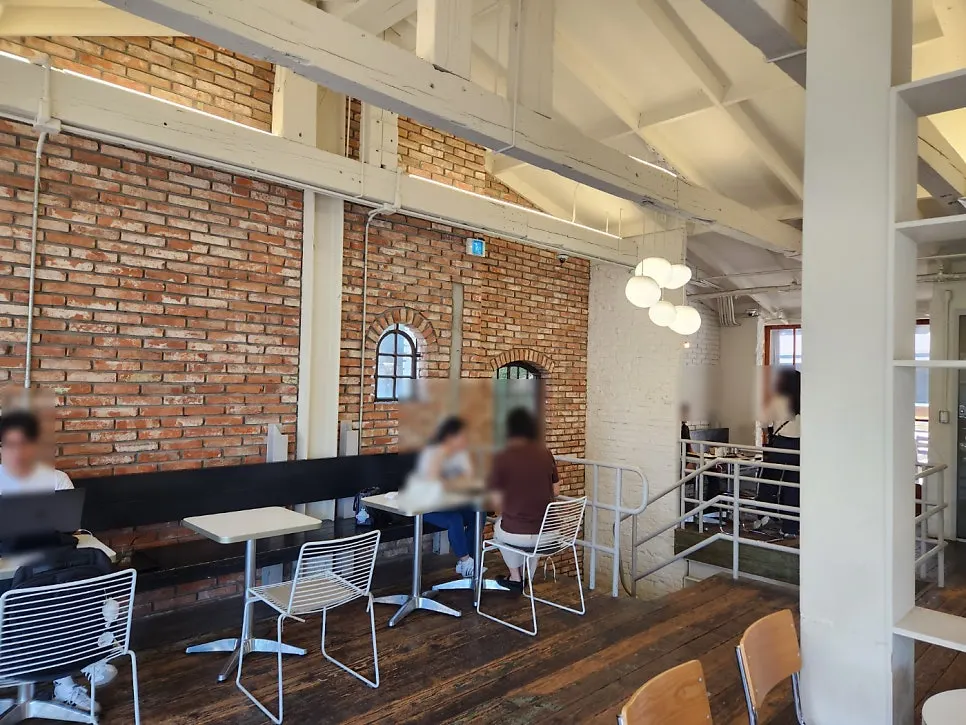 Outdoor terrace seating at Upper and Under with a view of trees