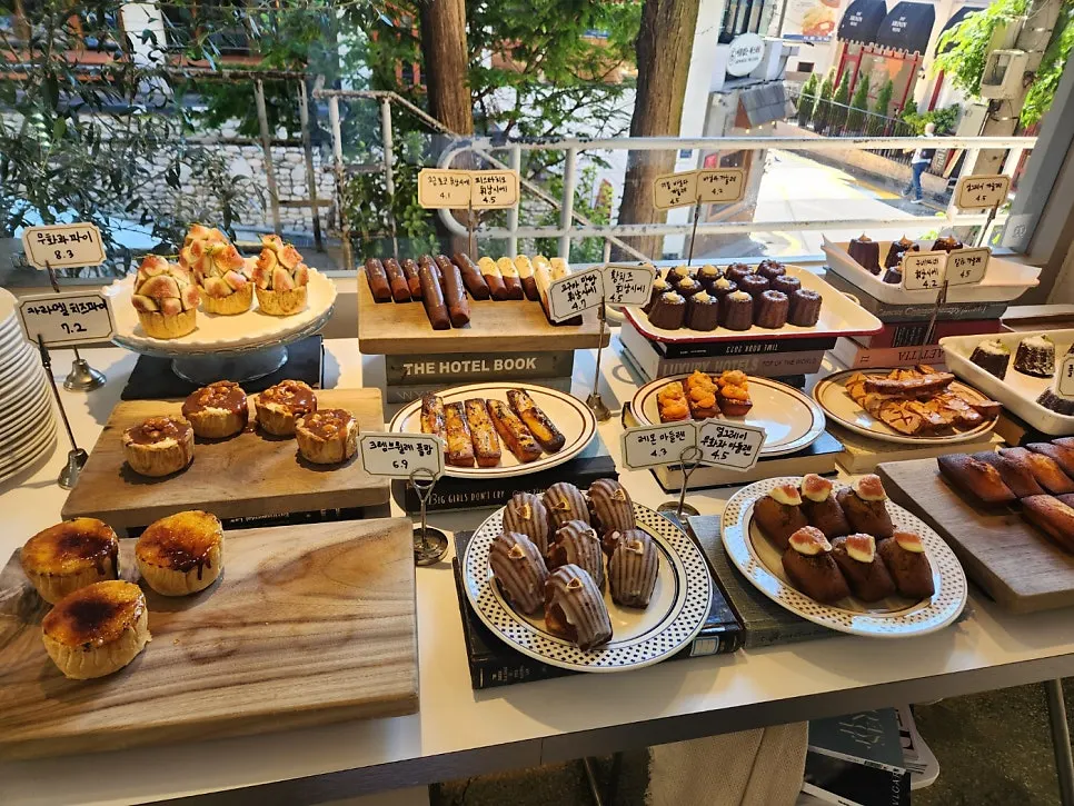 Upper and Under display case full of baked goods and tarts