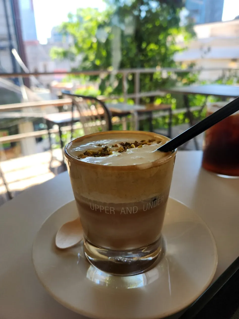 Iced pistachio cream latte topped with cream