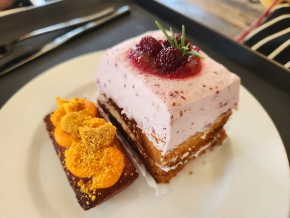 Hwangchiju financier and raspberry cake set next to the drinks