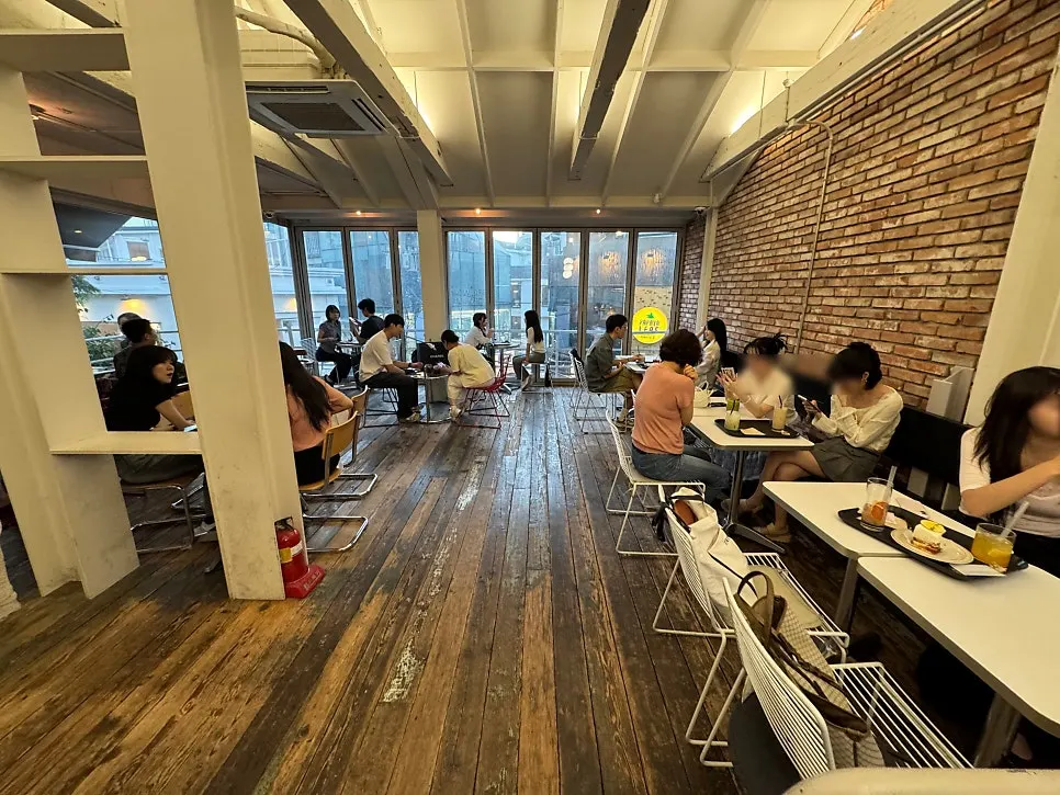 Indoor seating at Upper and Under with floor-to-ceiling windows