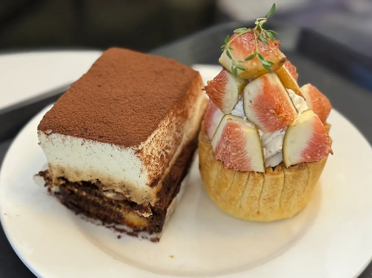 Table with fig pie, tiramisu, and drinks