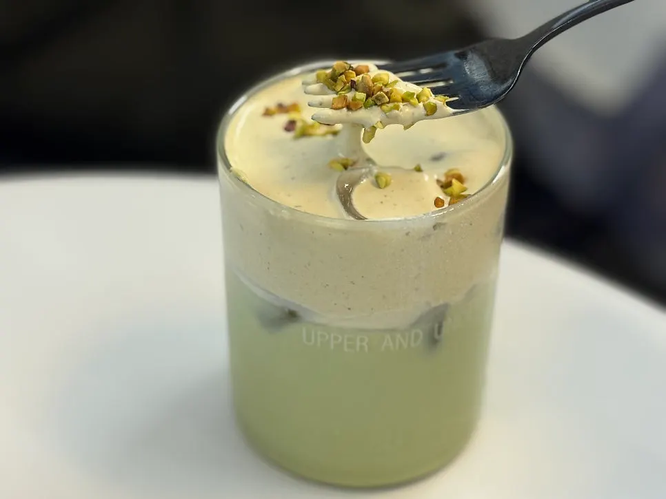 Matcha pistachio drink topped with pistachios