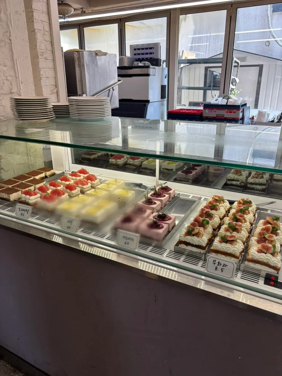 Large fruit-topped slice cakes on display