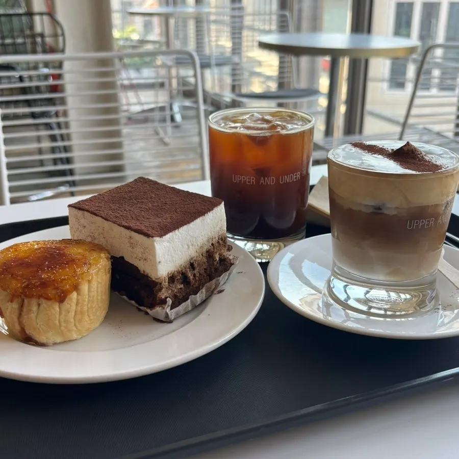 Two large dessert slices with an iced drink