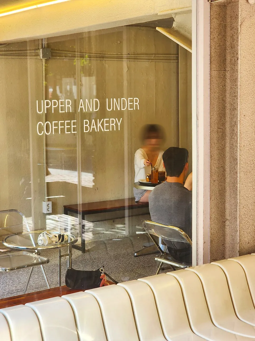 UPPER AND UNDER sign against the brick wall