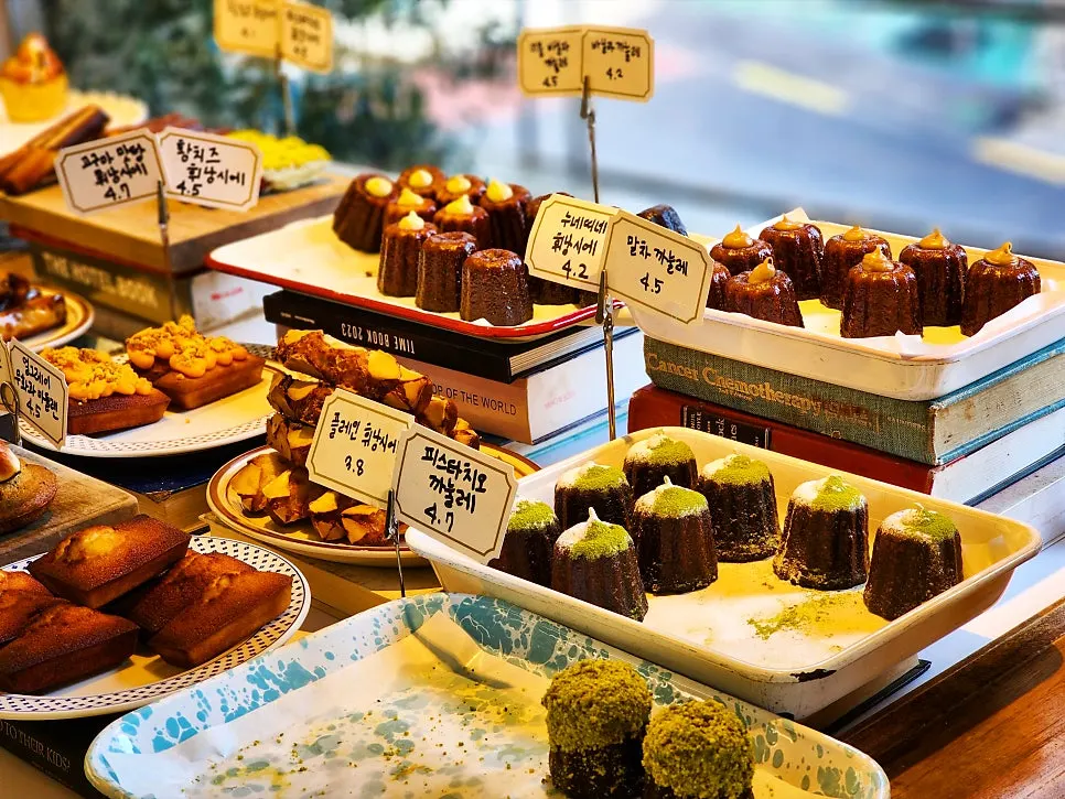 Bakery counter displaying canelés and madeleines