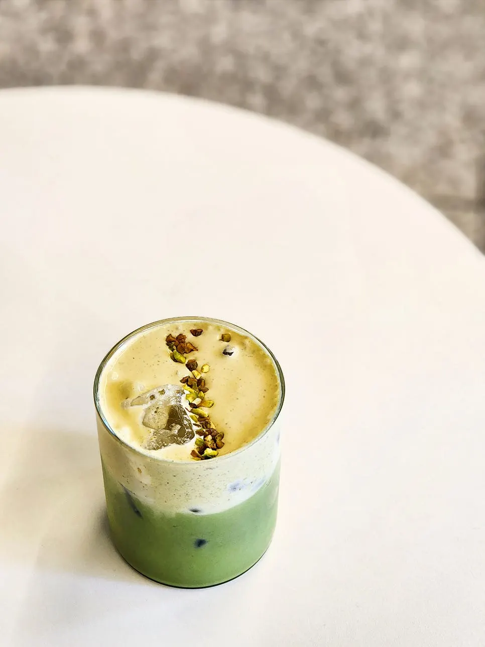 Matcha cream latte topped with pistachio cream