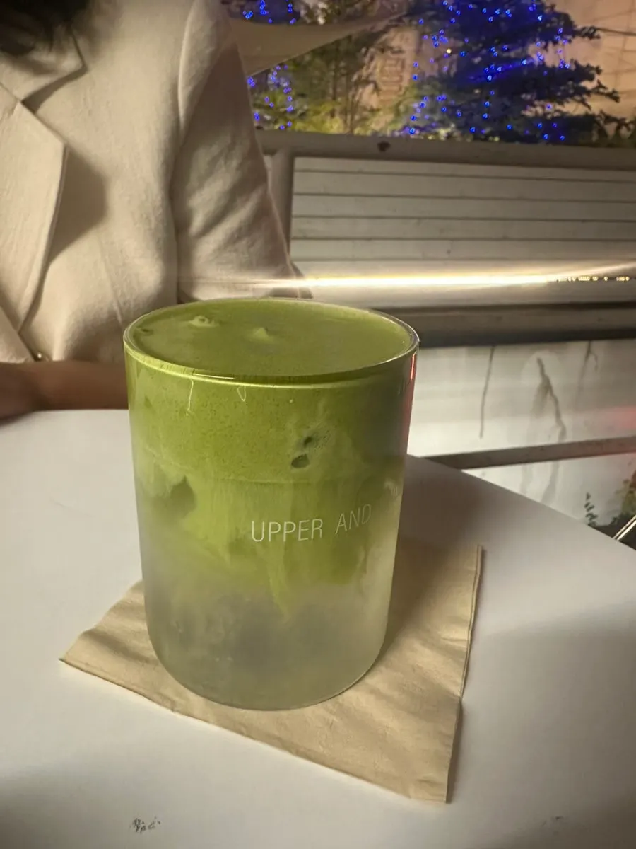 A cup of coconut matcha topped with cream