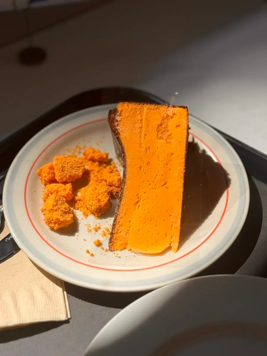 A slice of yellow cheese Basque cheesecake
