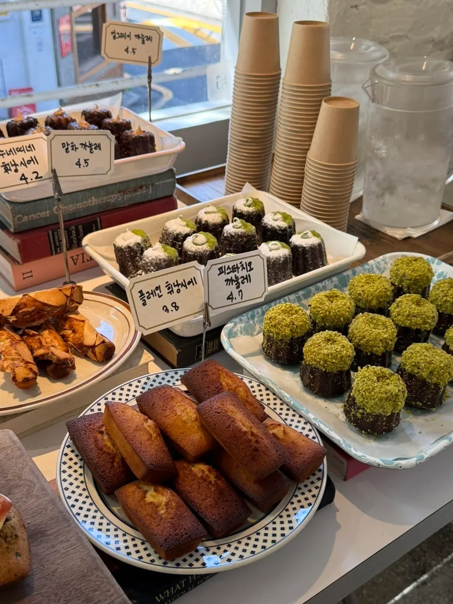 Dessert display case with financiers and canelés