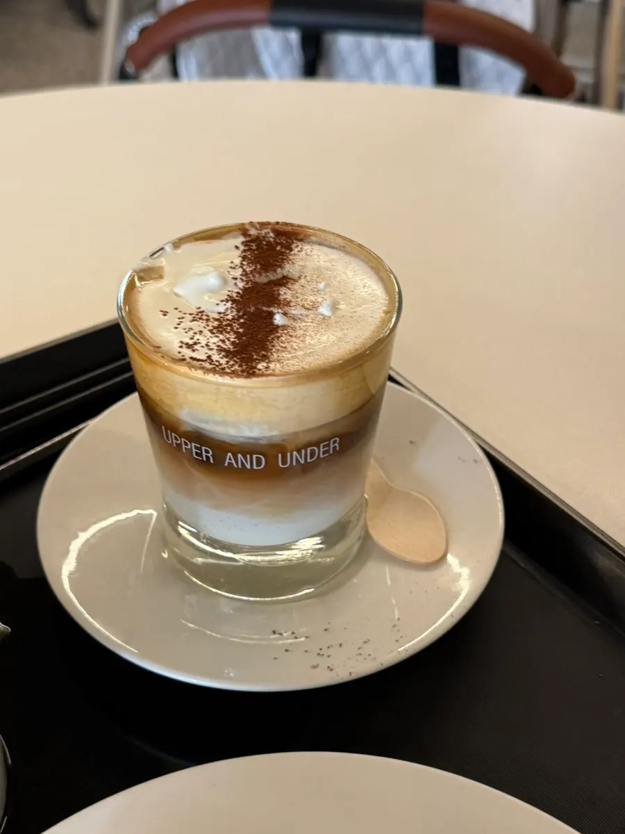 A canelé placed next to a cup of coffee