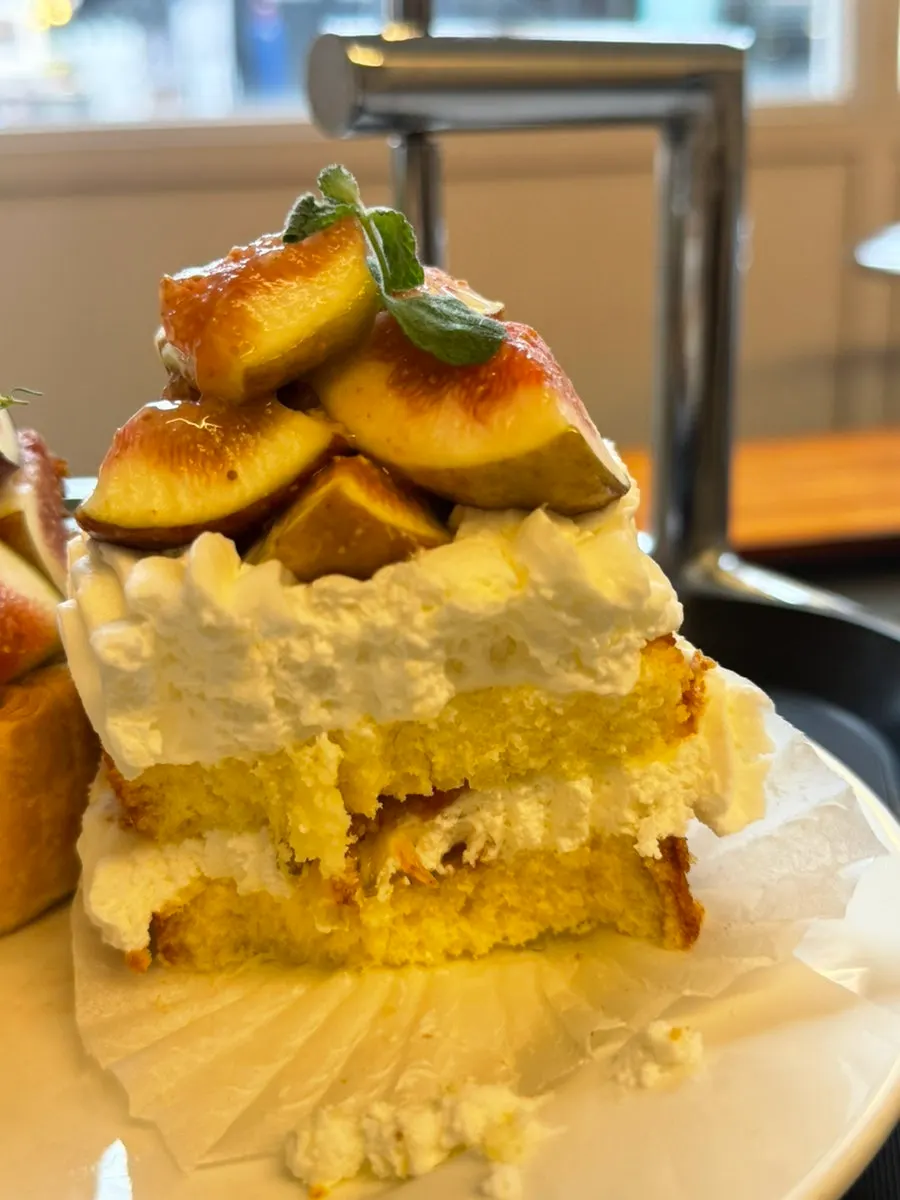 A slice of fig cake with a bite taken out