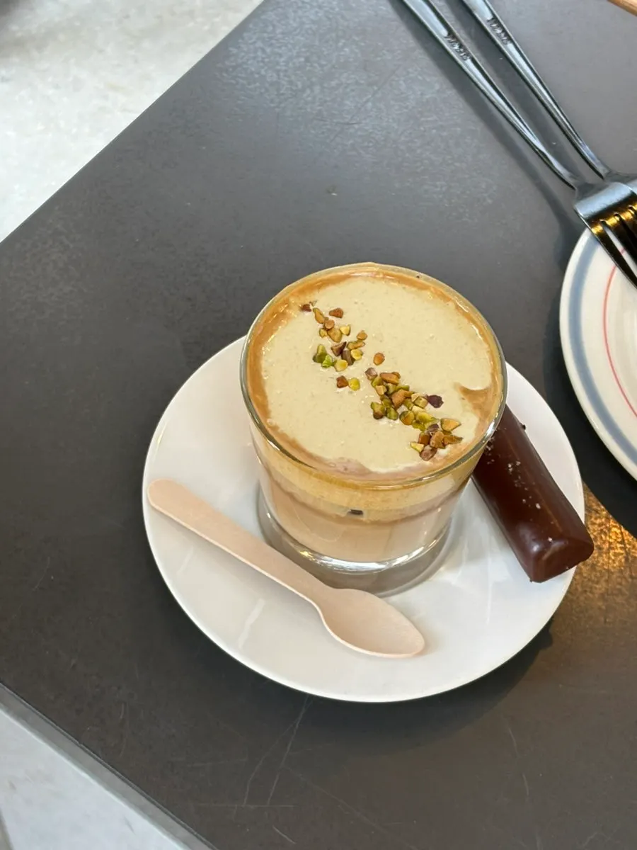 Pistachio cream latte topped with cream