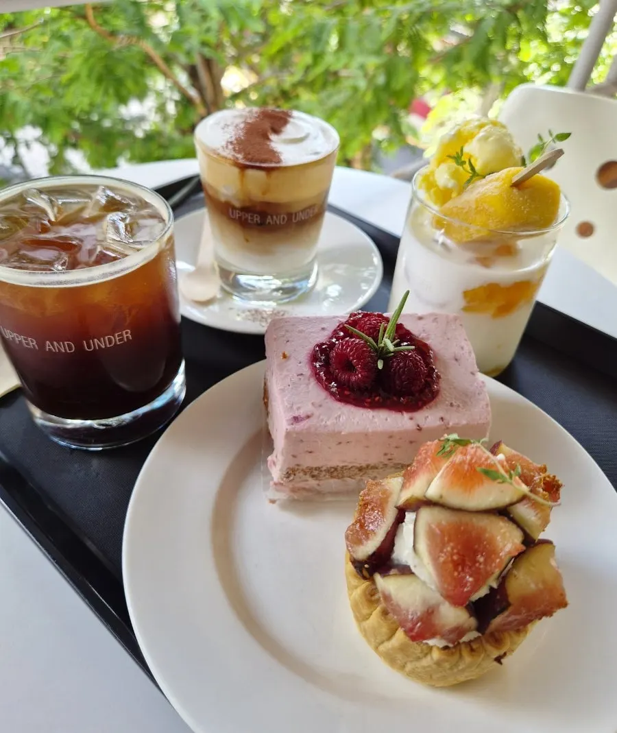 Three drinks and two desserts laid out on the terrace table