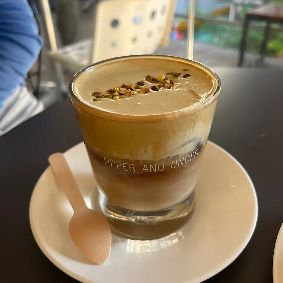 Pistachio cream latte topped with cream
