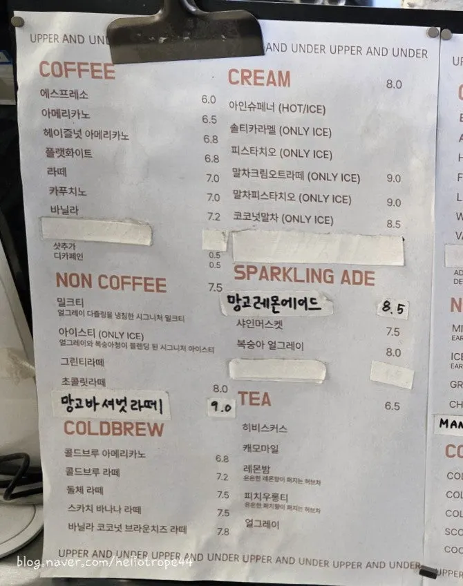 Signature cream coffee menu board at Upper and Under
