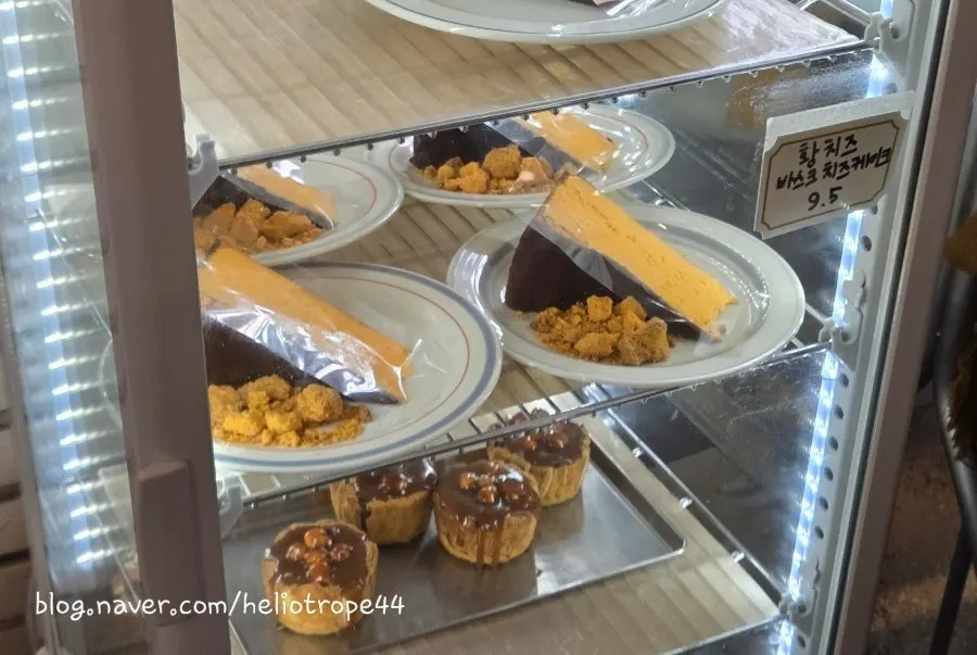 Cake display featuring the yellow cheese Basque cheesecake