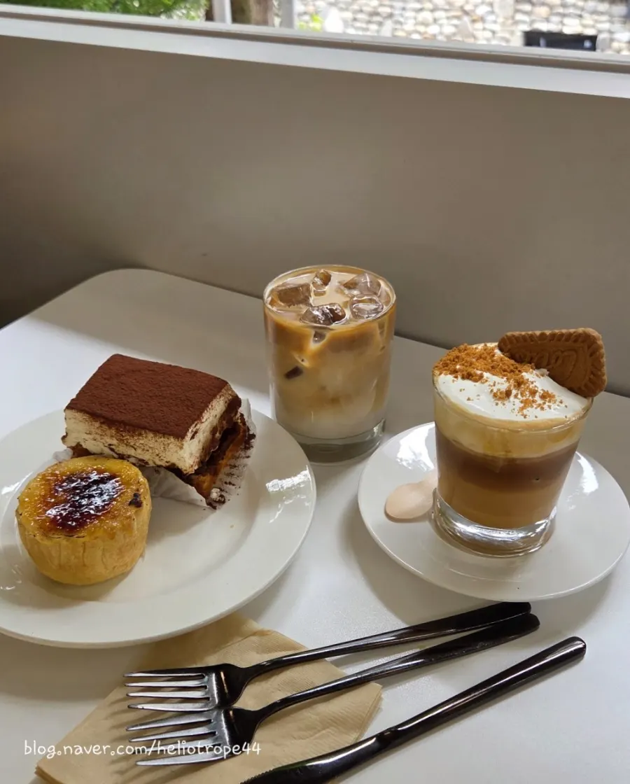 Table with tiramisu, crème brûlée flan and drinks together